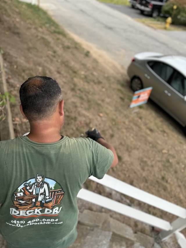 Paul painting a railing